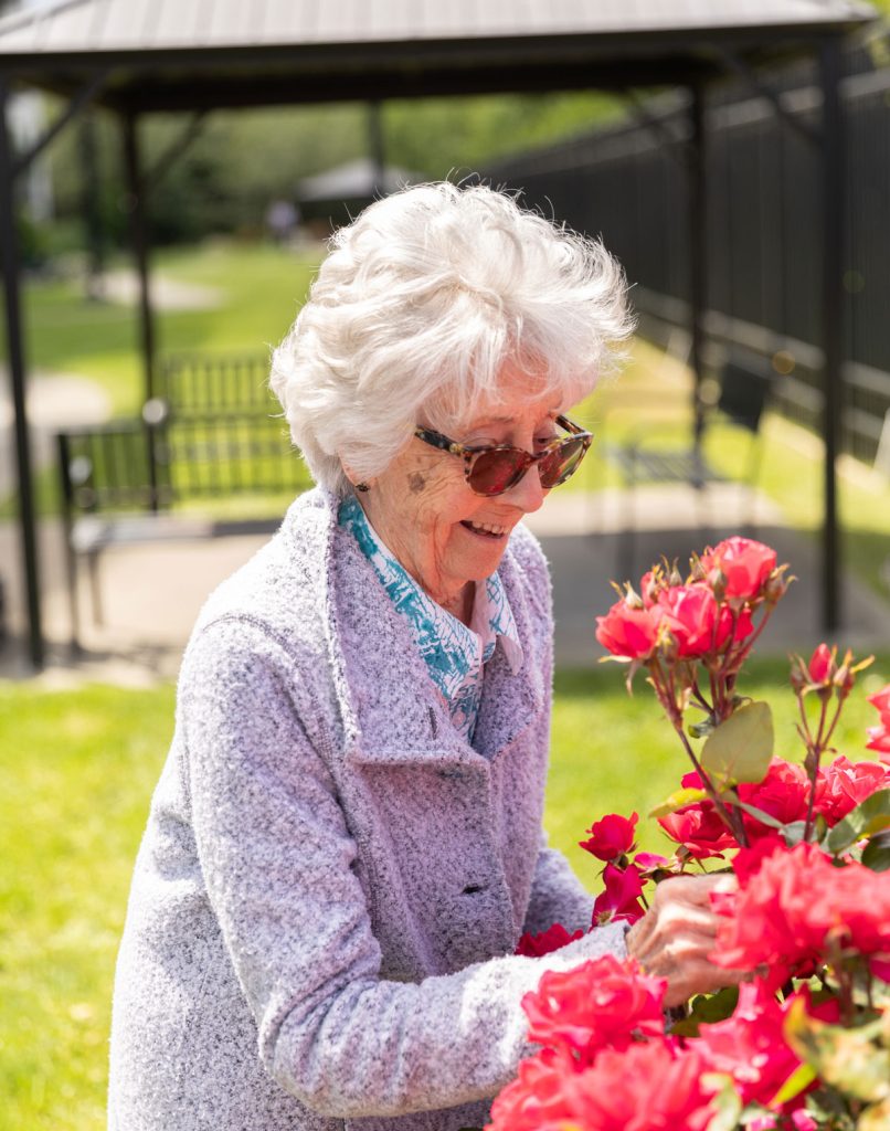 resident outside with flowers