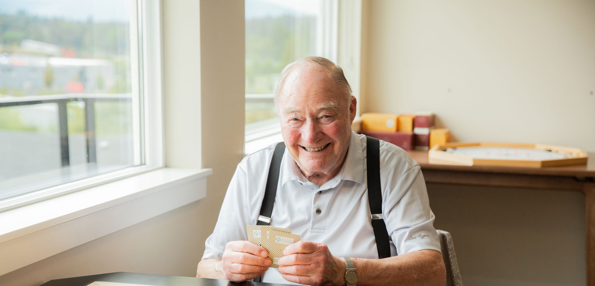 smiling resident playing cards