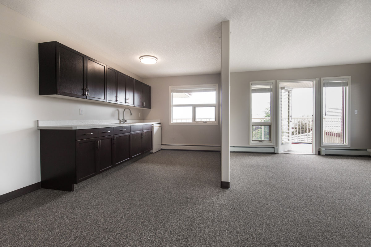 suite living area with kitchen and balcony