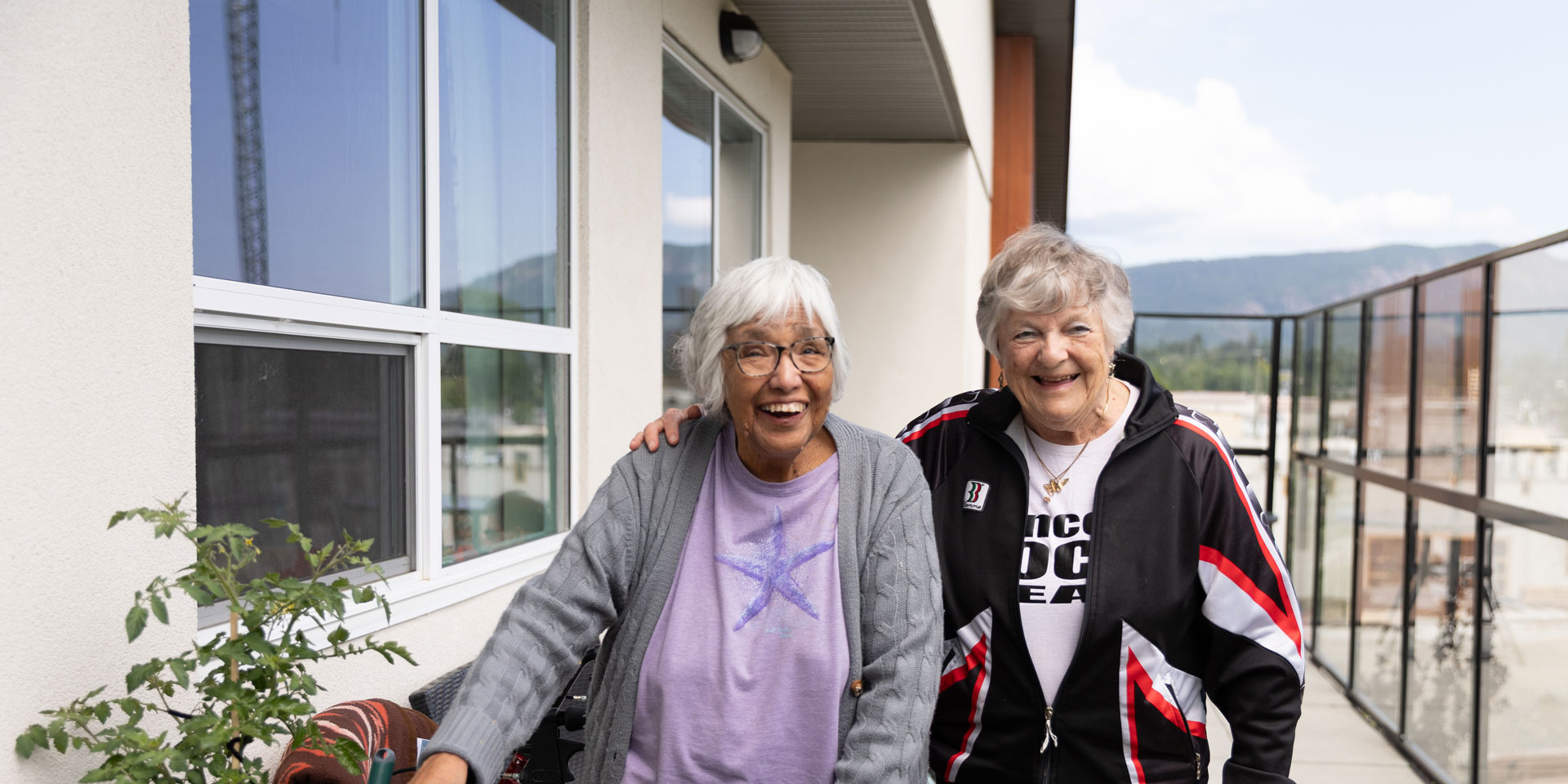 two smiling residents outside